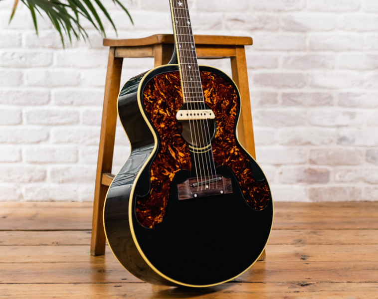 Gibson Cat Stevens J-180 apoyada en taburete